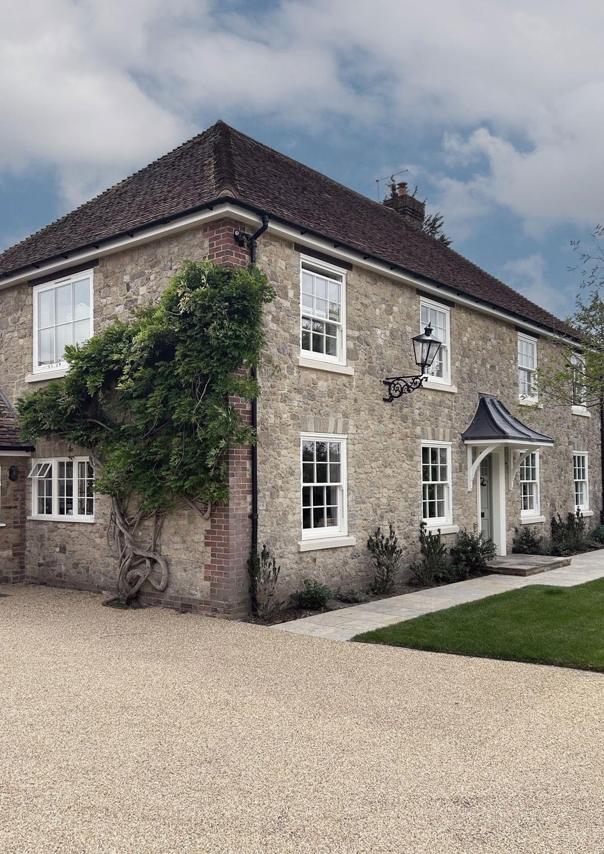 Rose Collection sash windows on a stone home