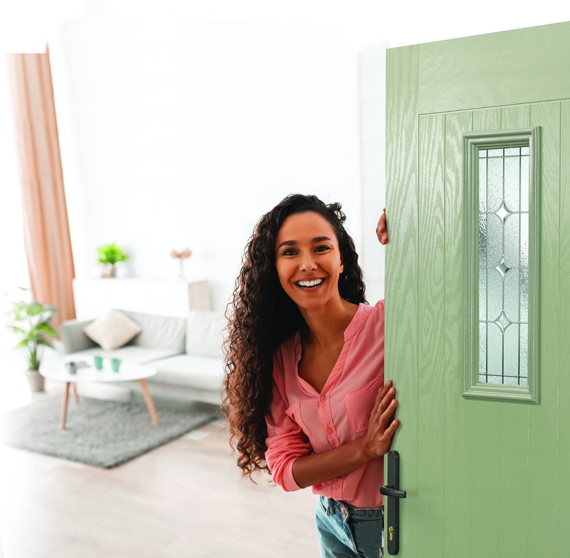 Homeowner welcoming a visitor through a green entrance door