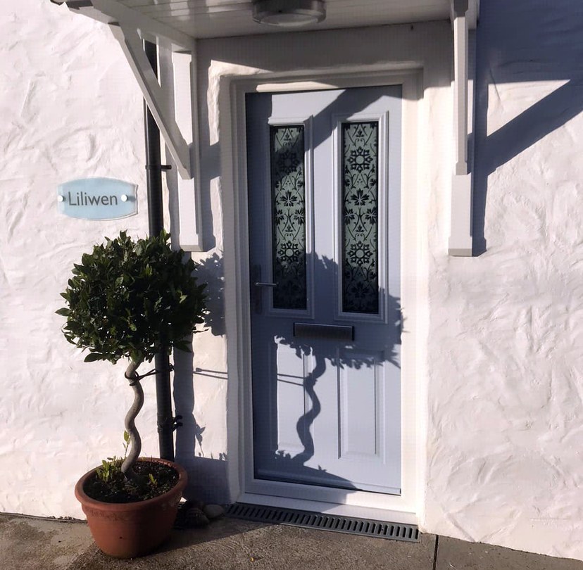 White glazed entrance door beneath a porch