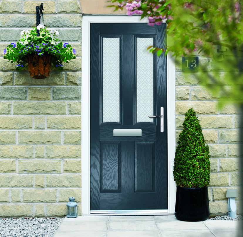 Dark entrance door installed in a stone home