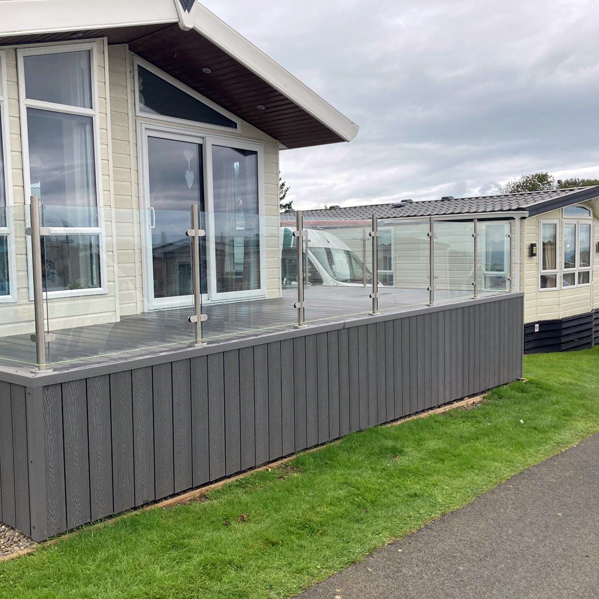 Glass balustrade with stainless-steel posts around a raised deck